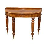 A Victorian mahogany gallery back demi-loon front hall table with drawer, on brass cup casters.