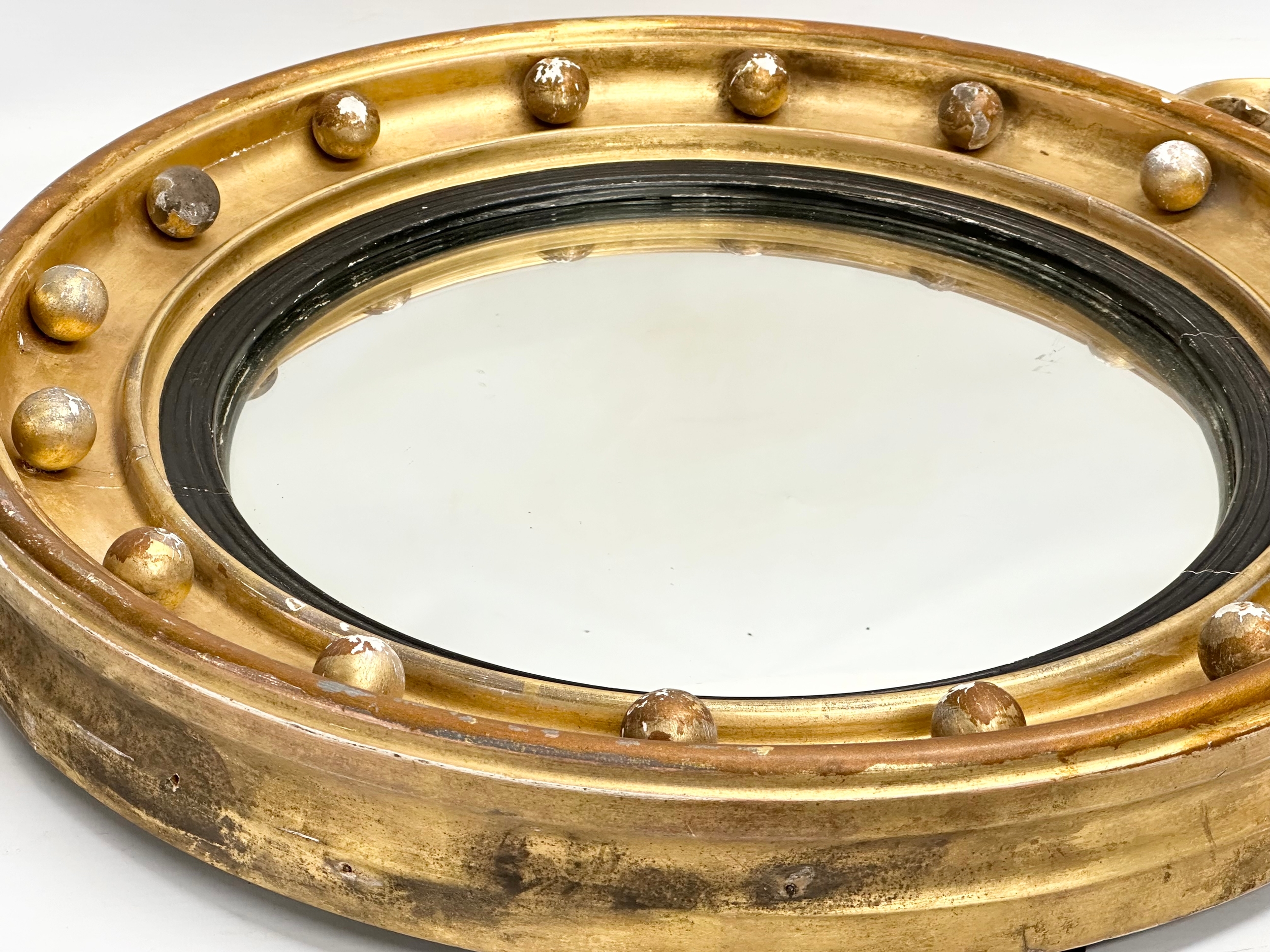 An early 19th century Regency period gilt framed convex mirror with an early 20th century back. - Image 5 of 7
