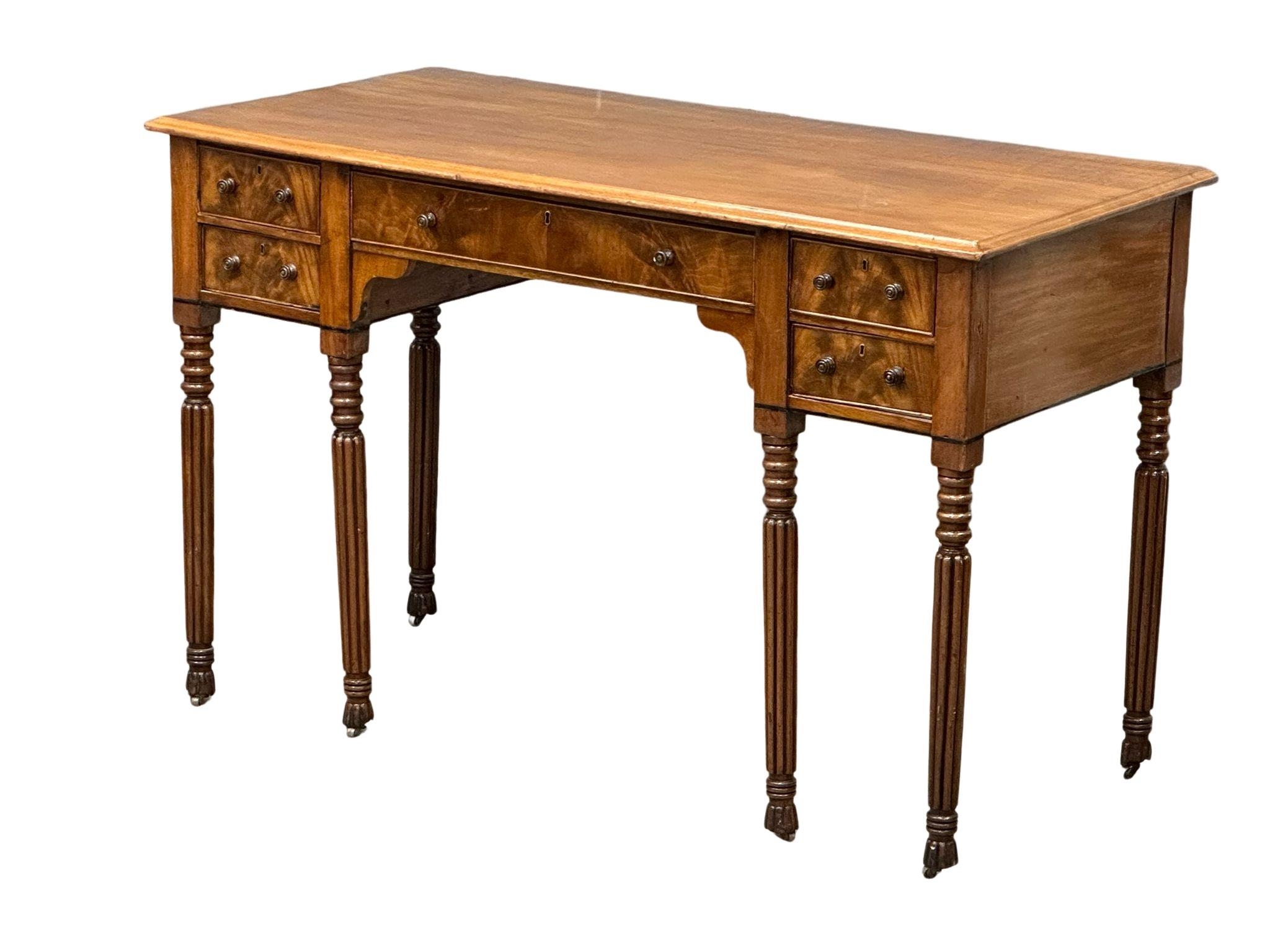 A late George IV mahogany side table/desk on reeded legs. 126cm x 61cm x 80cm - Image 2 of 9