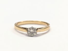 A 9ct gold and diamond ring. 1.8g. Size UK N.