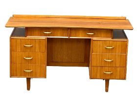 A Mid Century walnut desk/dressing table, 131cm x 49cm x 74.5cm
