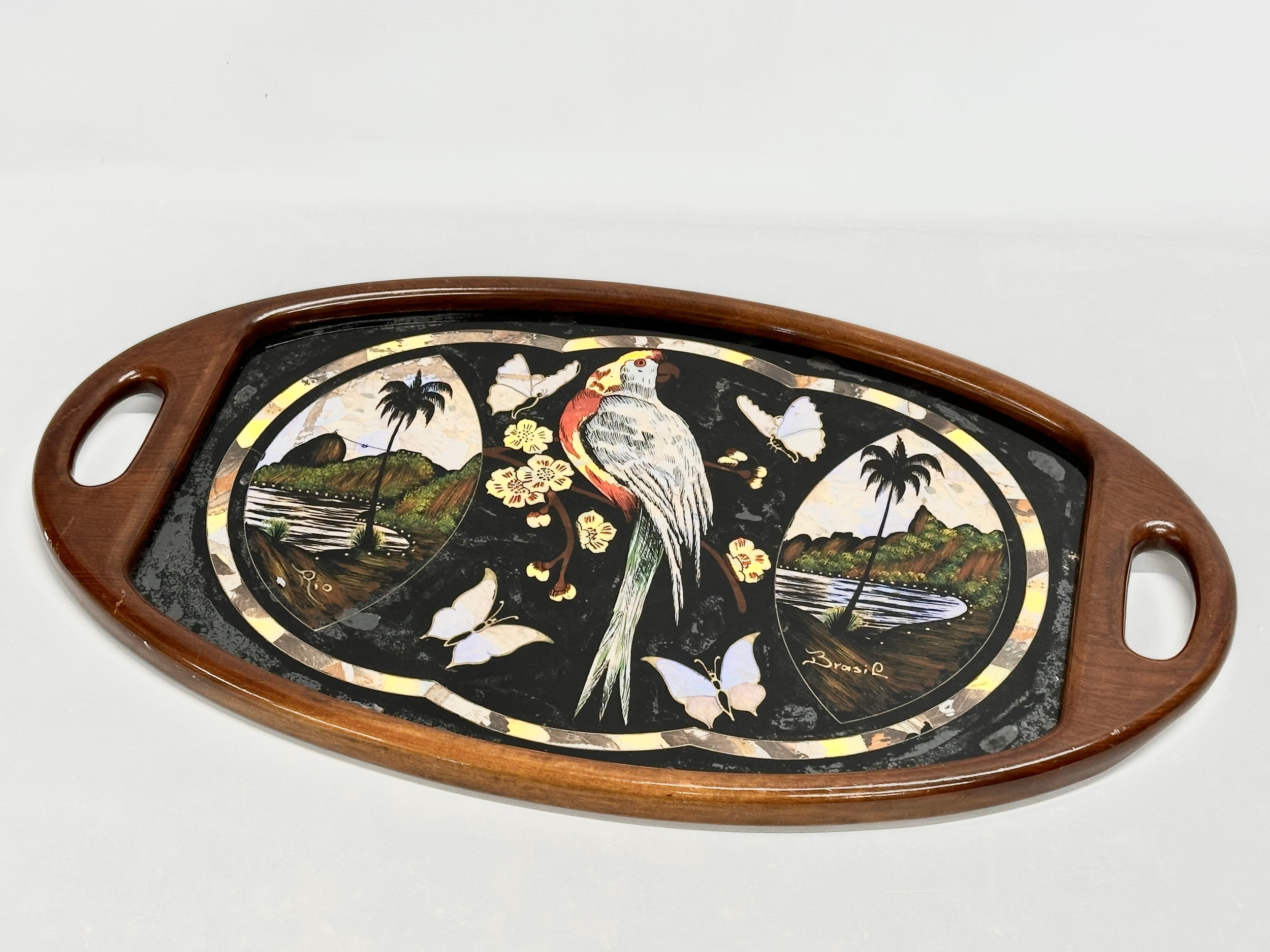 A Mid 20th Century Brazilian serving tray with Mother of Pearl parrot and butterfly design. 70x41cm