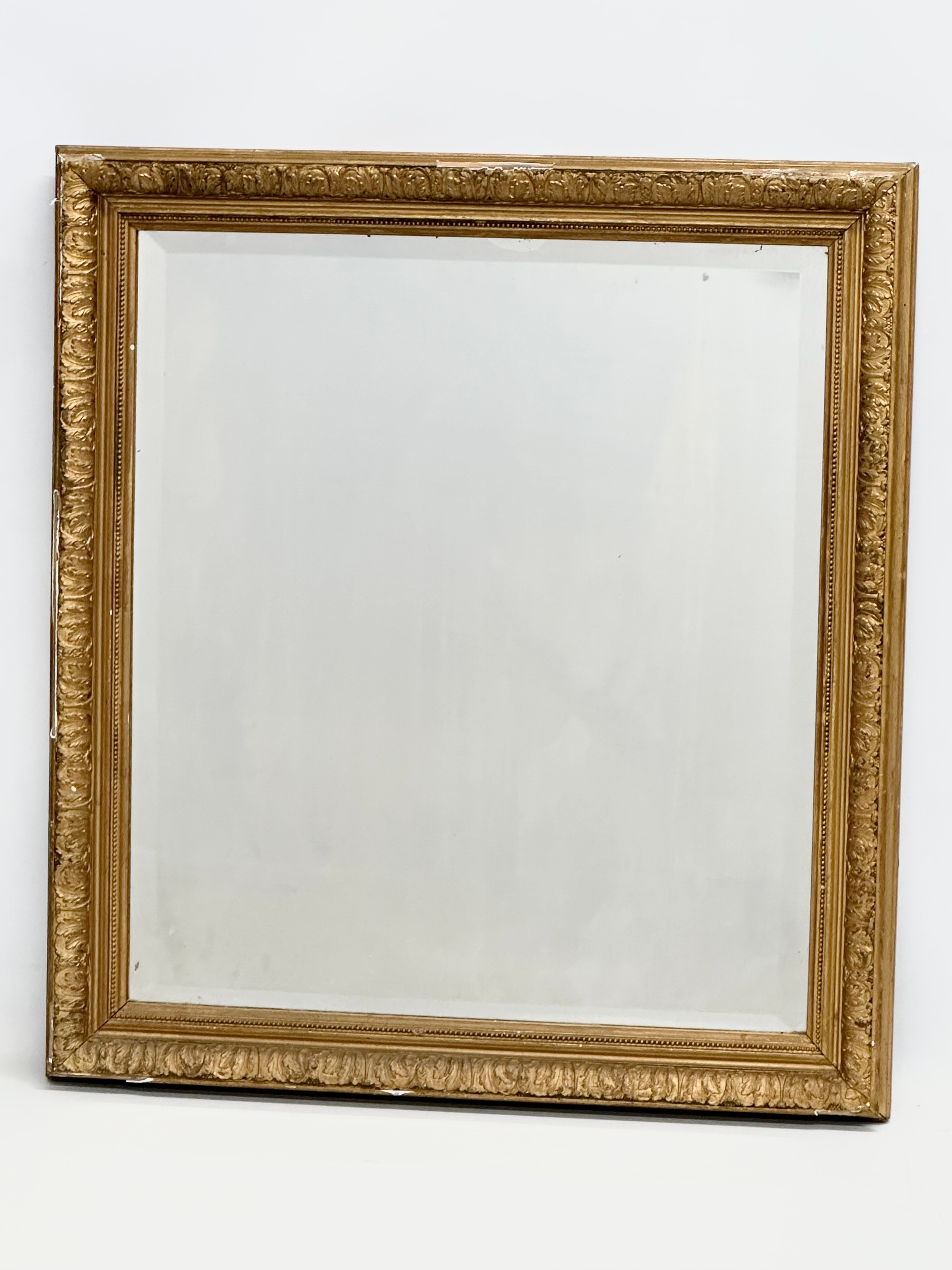 A Late Victorian gilt framed bevelled mirror. 56x61.5cm
