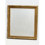 A Late Victorian gilt framed bevelled mirror. 56x61.5cm