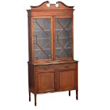 An early 20th century Sheraton revival inlaid mahogany bookcase with astragal glazed doors and