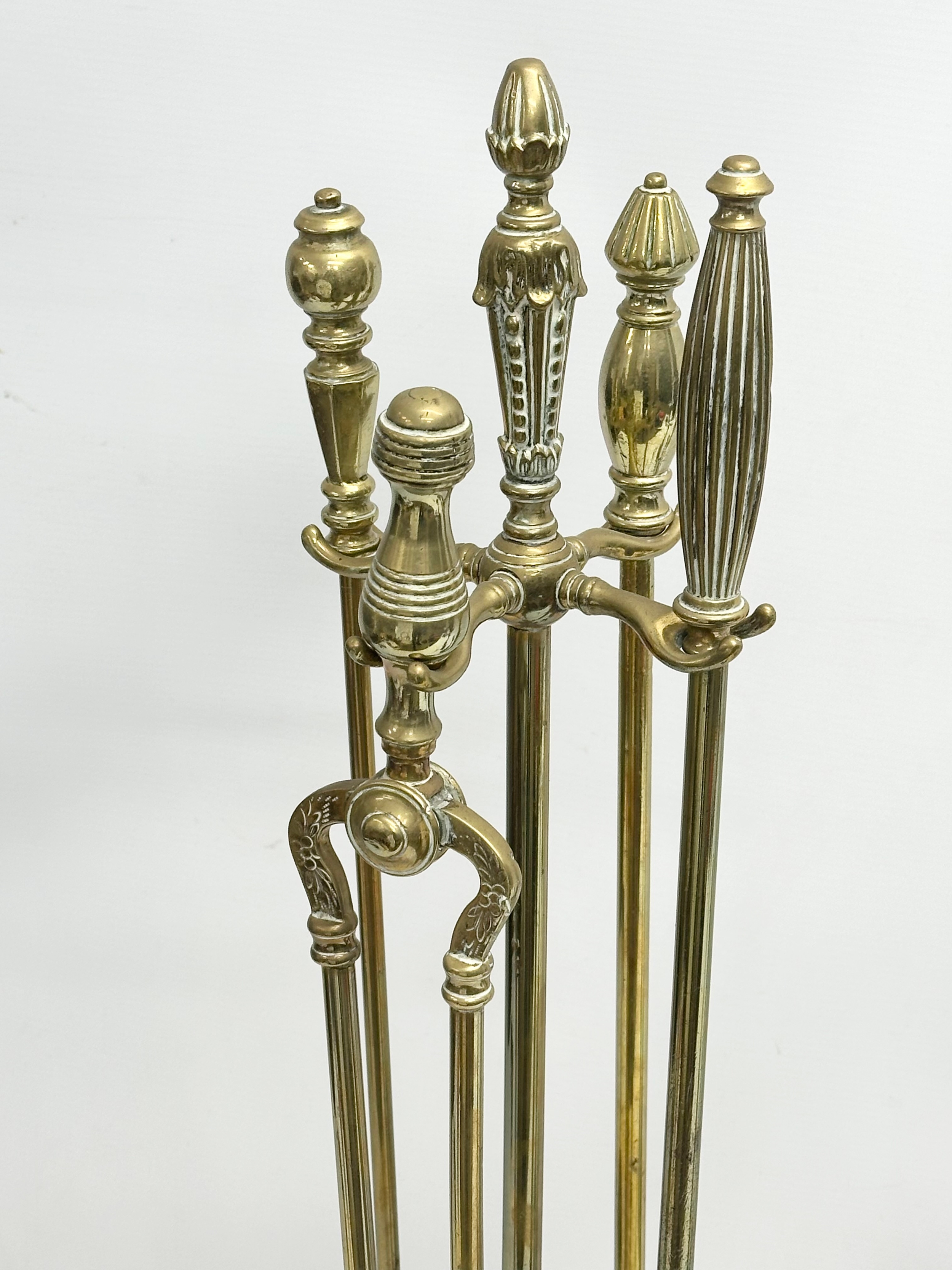 A quantity of Late Victorian brass fire tools and doorstops. A large Victorian brass companion set - Image 4 of 6