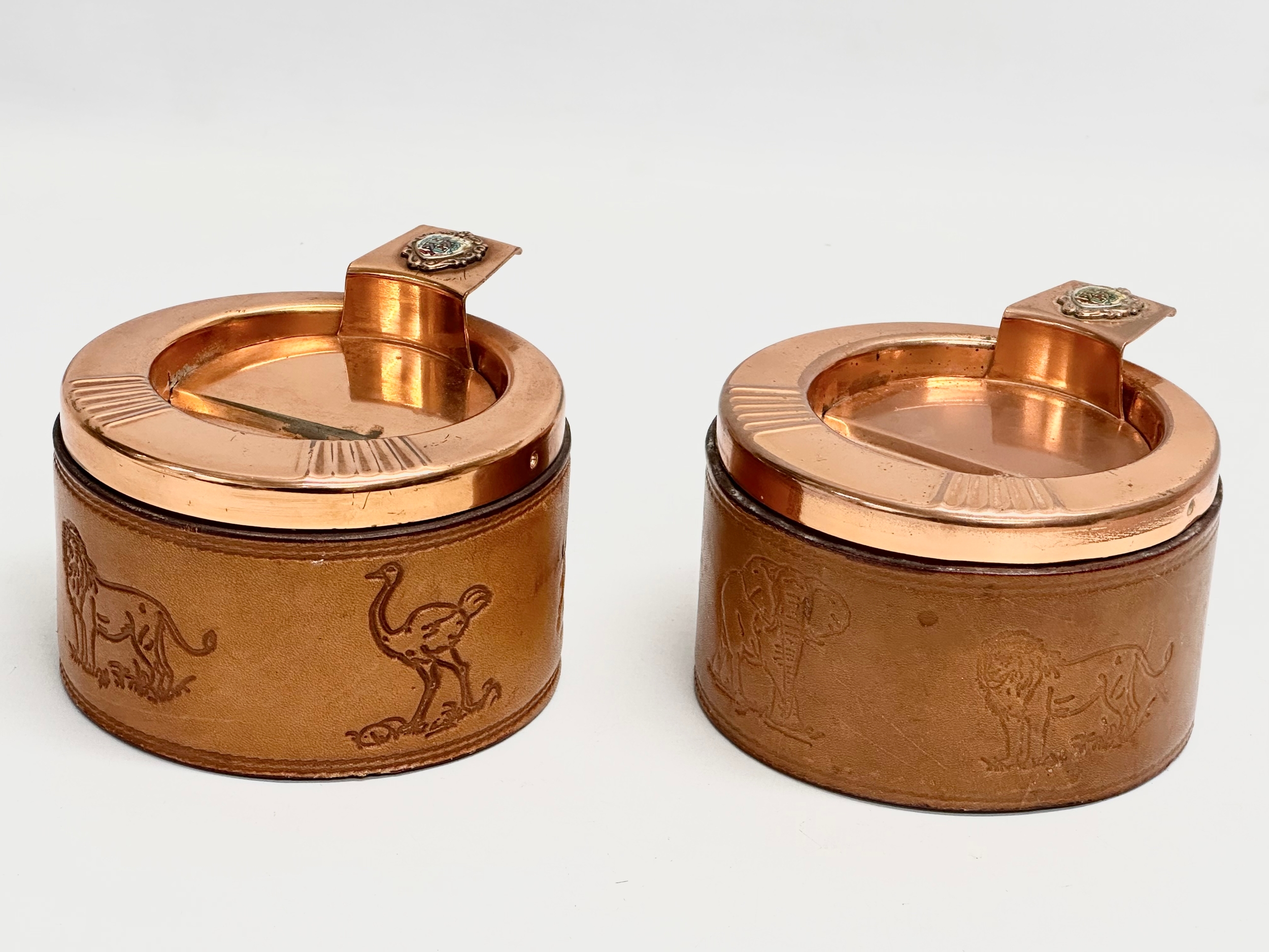 A pair of South African Durban Lines ships copper and leather bound ashtrays. 11.5x13x8cm