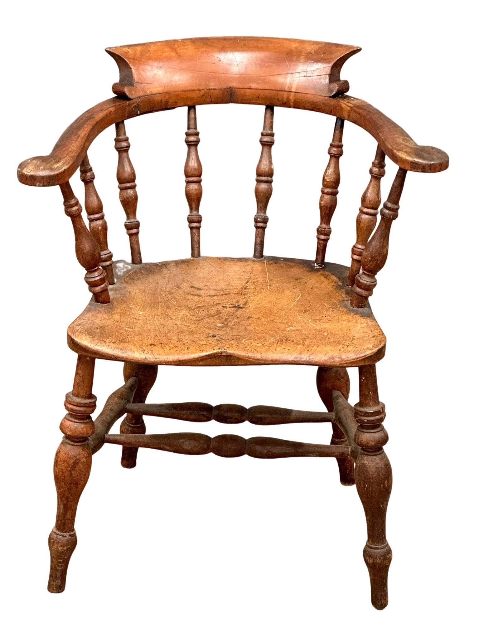 A Mid Victorian elm and beech elbow chair.