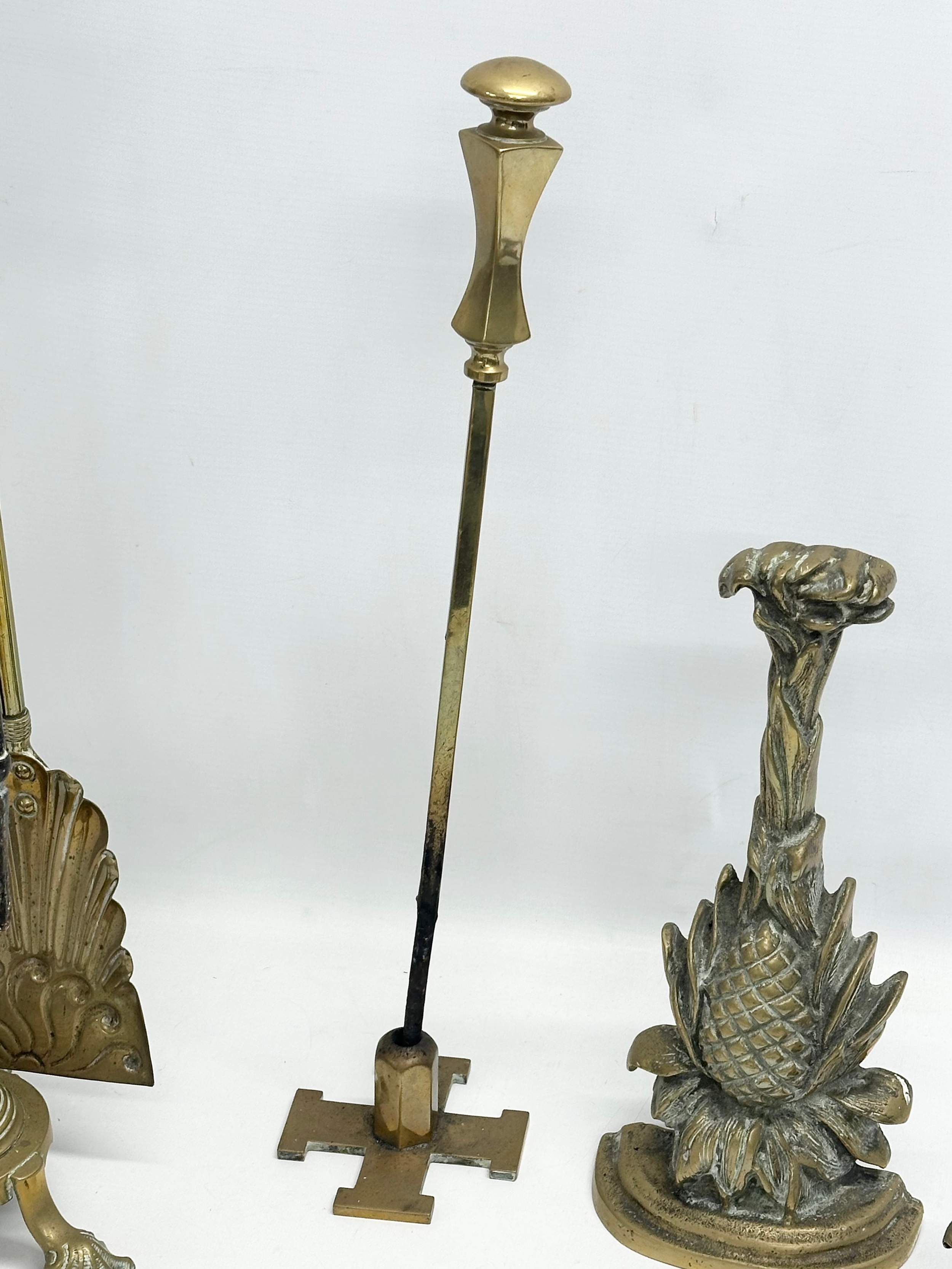 A quantity of Late Victorian brass fire tools and doorstops. A large Victorian brass companion set - Image 3 of 6