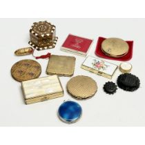 A collection of vintage compacts and brooches.