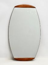 A Mid Century teak framed bevelled wall mirror. 38x68cm
