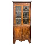 A George III inlaid mahogany corner display cabinet with astragal glazed doors. Circa 1800.