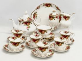 A 23 piece Royal Albert ‘Old Country Roses’ tea service. Teapot, 2 sugar bowls, milk jug, 6 sandwich