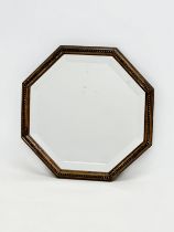 An Early 20th Century oak framed bevelled mirror. 1920-1930. 34x34cm.