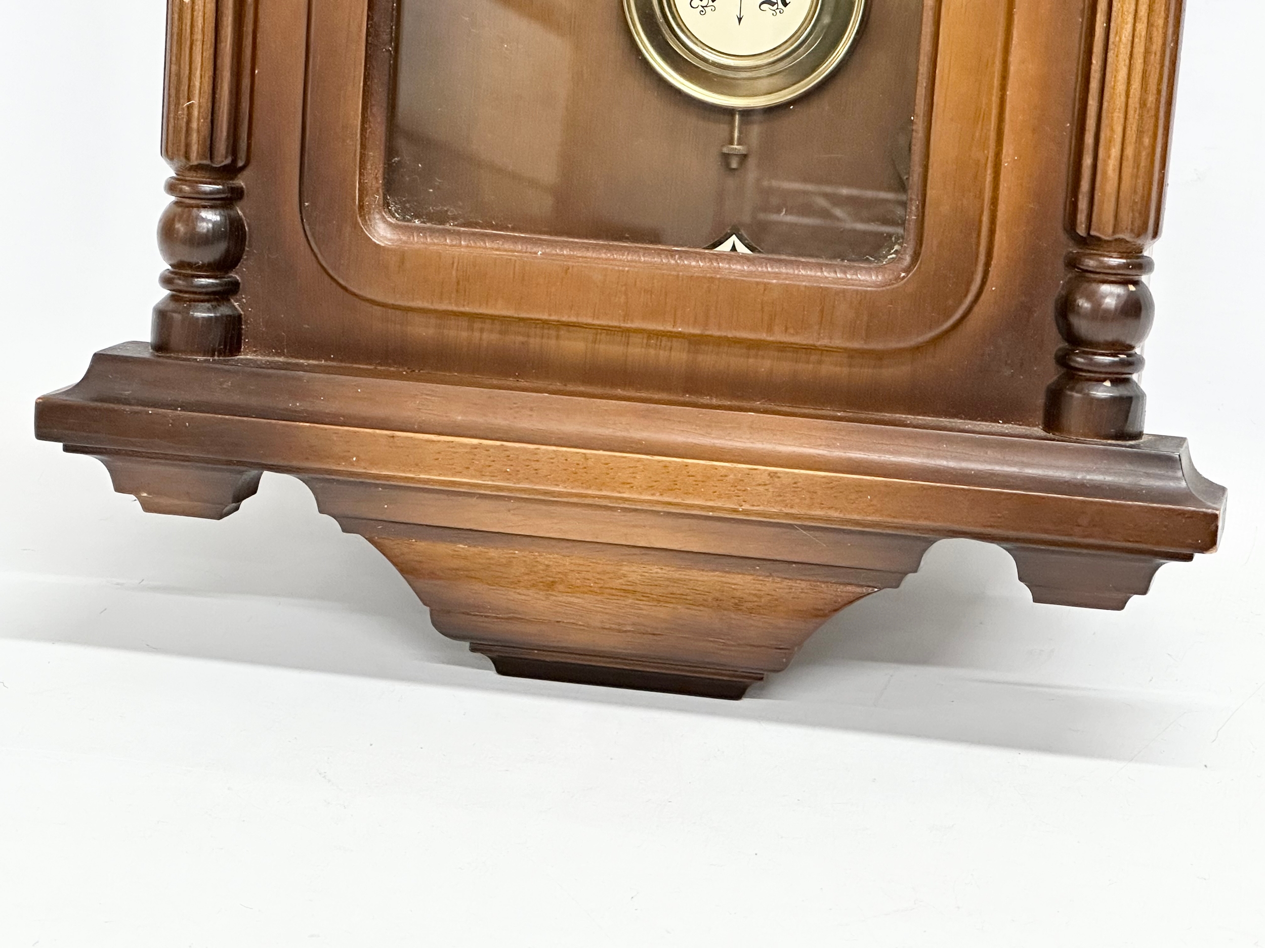 A 19th century style Schmeckenbecker wall clock. With key and pendulum. 63cm - Image 2 of 4