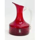 A Ruby Glass jug designed by Geoffrey Baxter for Whitefriars. 12x17cm