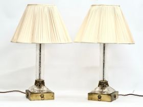 A pair of large table lamps with etched glass columns on brass bases and lion mask rings. 18x18x53cm