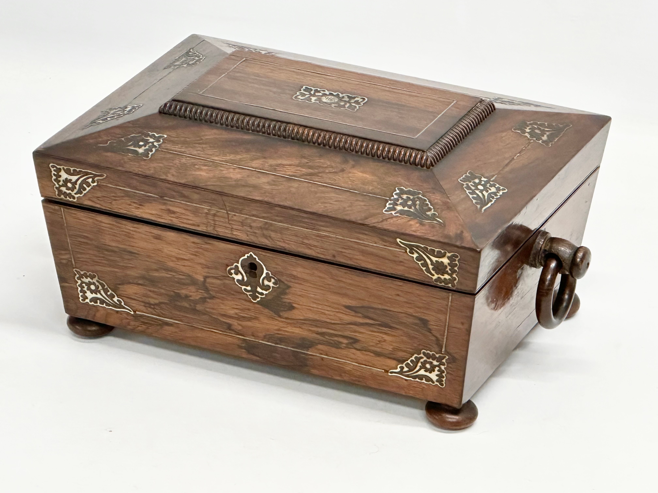 A Regency rosewood and Mother of Pearl sarcophagus shaped sewing box. Early 19th Century. Circa