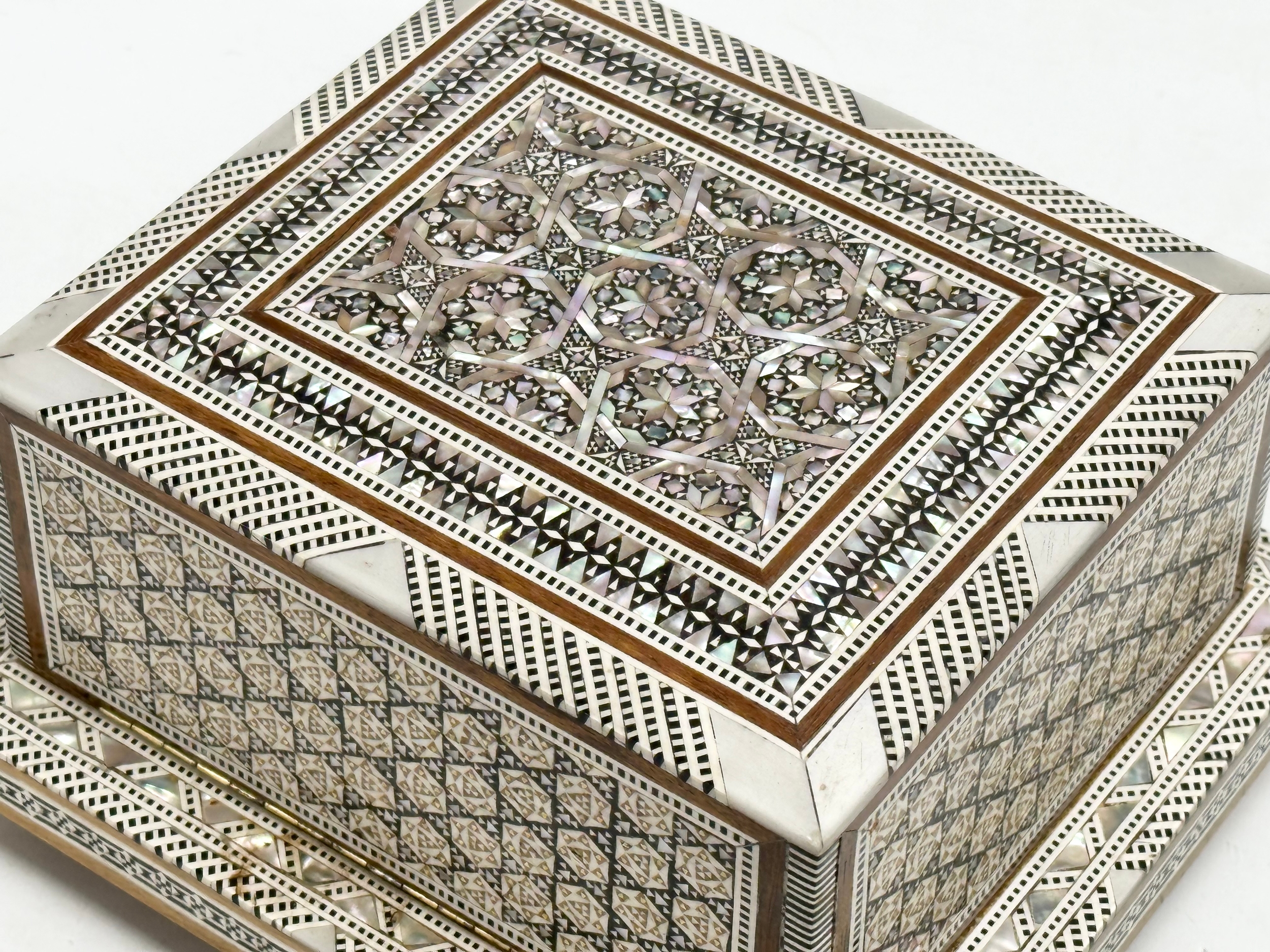 A Mother of Pearl inlaid musical cigarette box. 19x17x11cm - Image 4 of 5