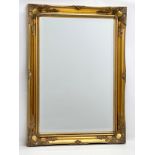 A large Victorian style gilt framed bevelled mirror by J.R. Annett. 66x91cm