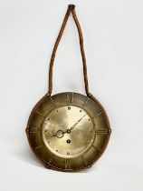 A 1960’s Mid Century brass wall clock. 25x49cm including rope.