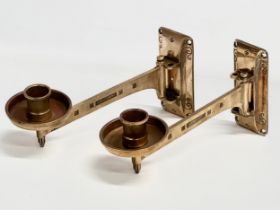 A pair of Late 19th/Early 20th Century brass wall mounted candleholders. Dep Muster. 23cm