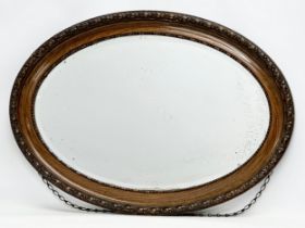 A large Early 20th Century bevelled mirror. 87x62cm