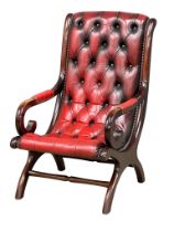 A Regency style deep button ox-blood leather armchair.