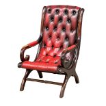 A Regency style deep button ox-blood leather armchair.