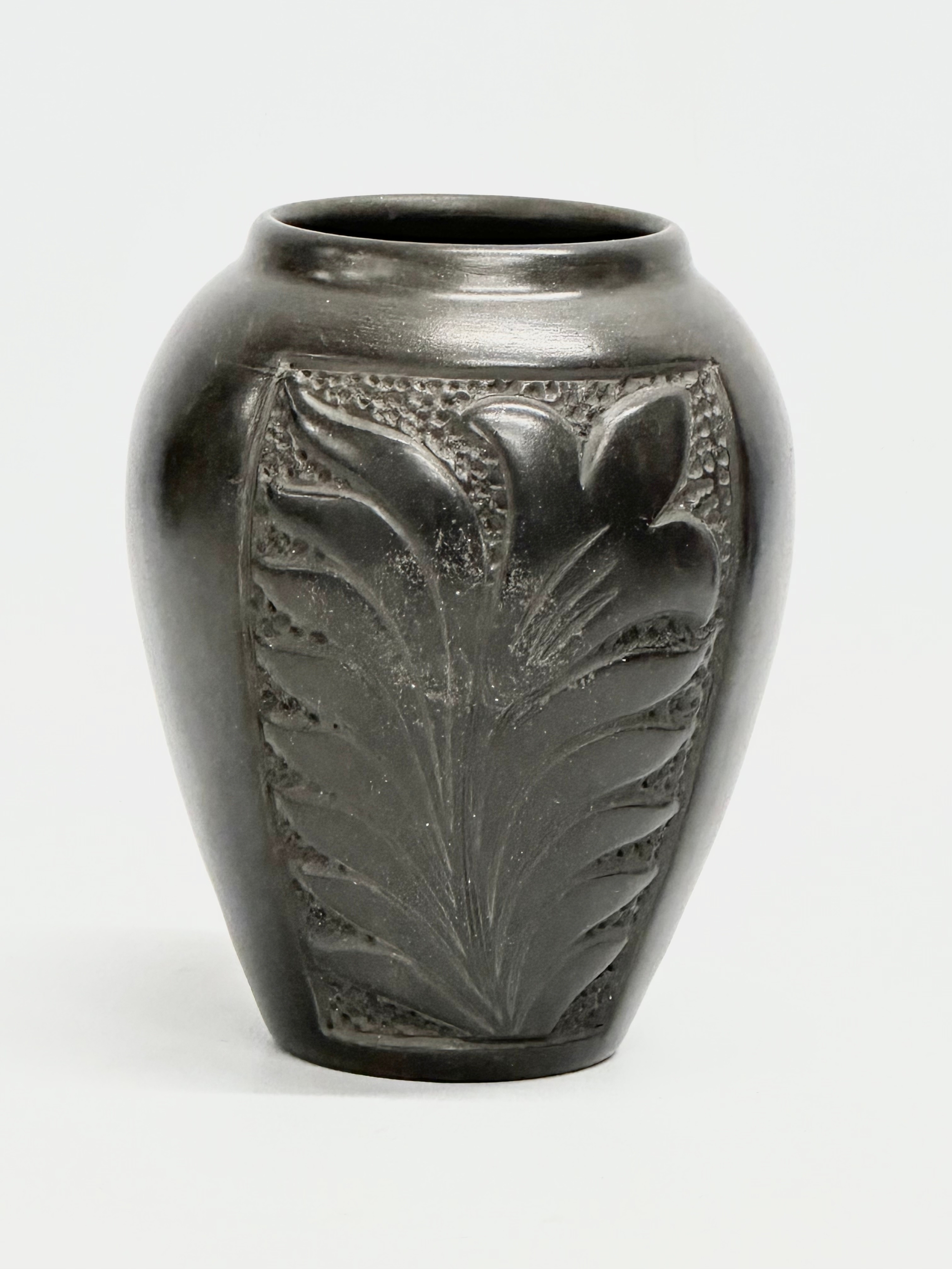 A black glazed ceramic pot by Marginea. 10x14cm