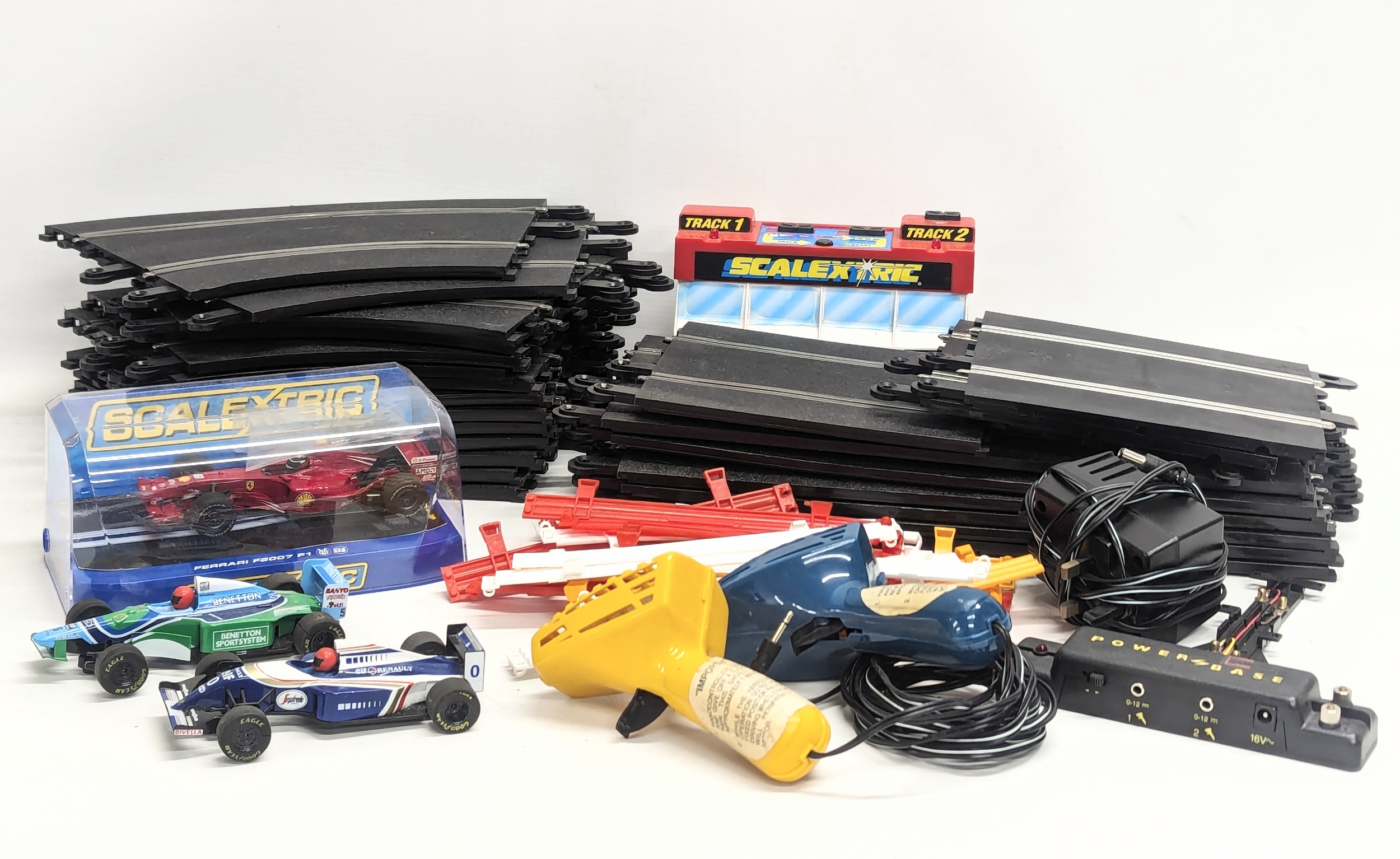 A vintage Scalextric race car track including 2 remotes, tracks, cars, transformer, etc