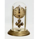 An Early/Mid 20th Century brass anniversary clock with key. 18x26cm