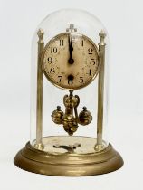 An Early/Mid 20th Century brass anniversary clock with key. 18x26cm