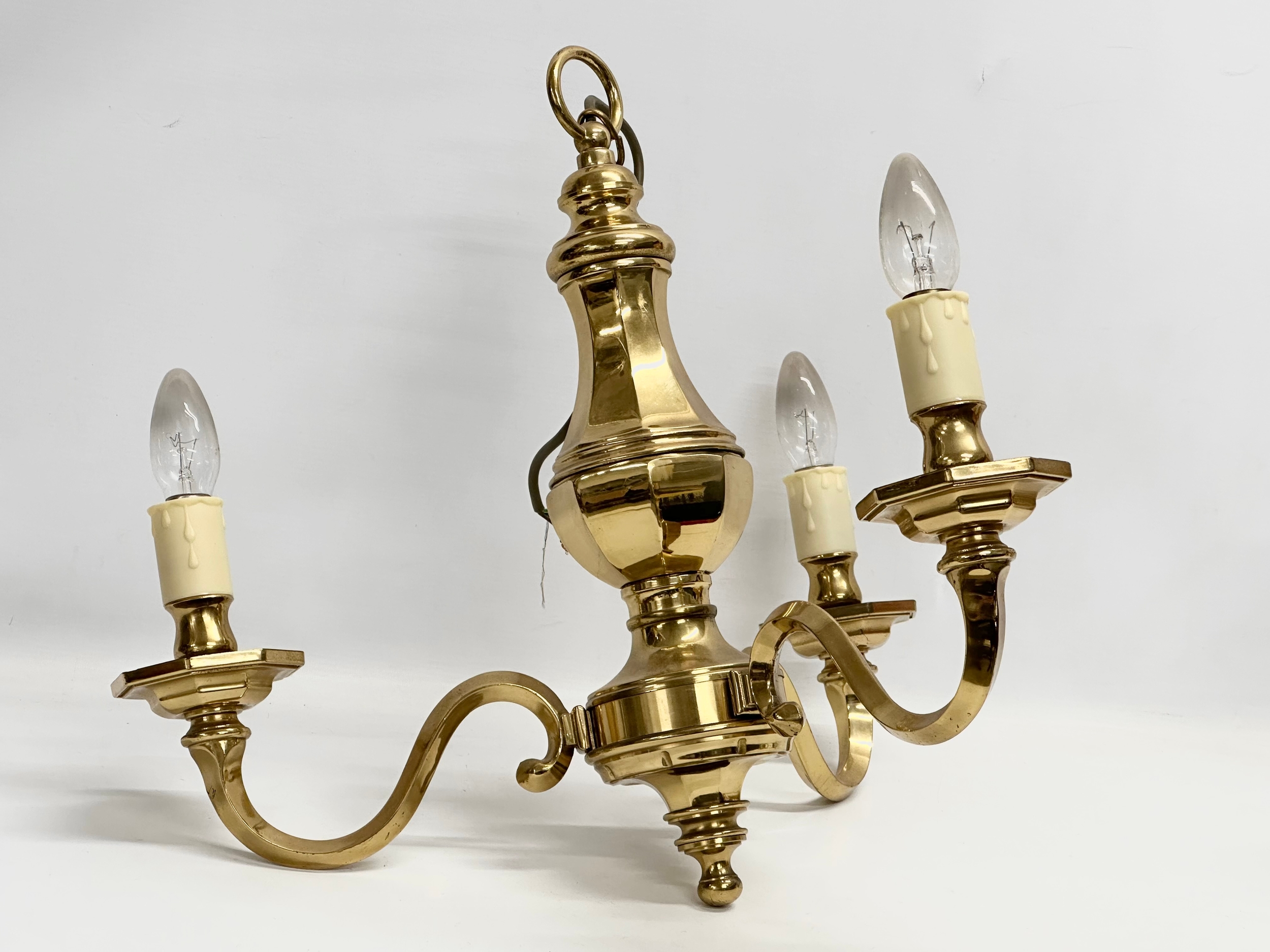 A pair of heavy brass chandeliers. 52x46cm - Image 2 of 2