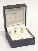 A pair of 9ct gold diamond earrings.