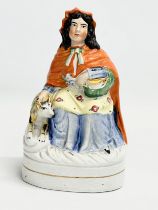 A rare Victorian ‘Little Red Riding Hood’ Staffordshire pottery figure. 12x9x20.5cm