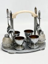 A 1920’s Art Deco chrome and Bakelite breakfast set. Egg cups, salt and pepper shakers and 4