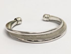 A silver bangle. 29.51g