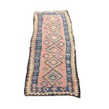 A large Middle Eastern style rug. 270x133cm