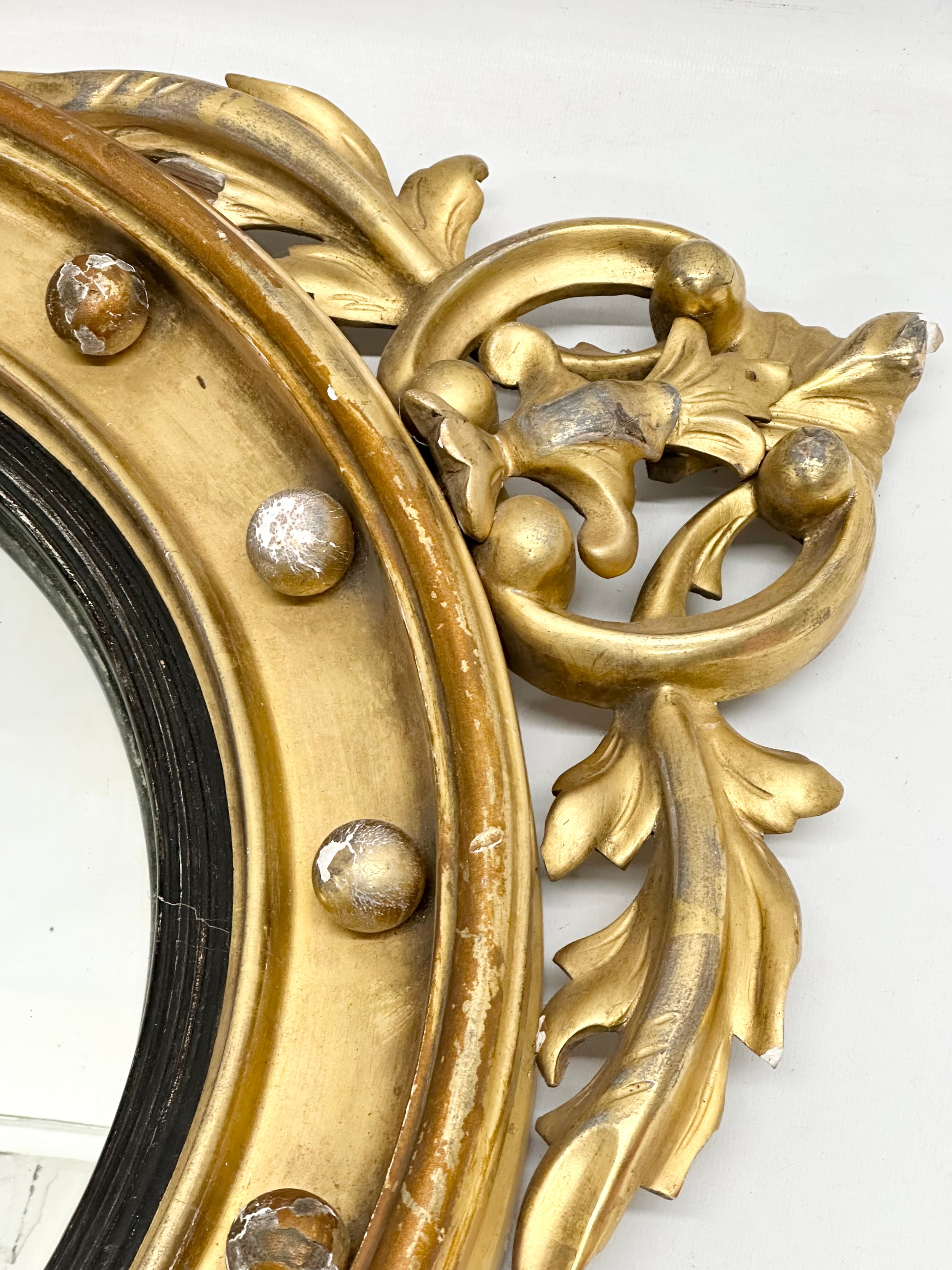 An early 19th century Regency period gilt framed convex mirror with an early 20th century back. - Image 3 of 7