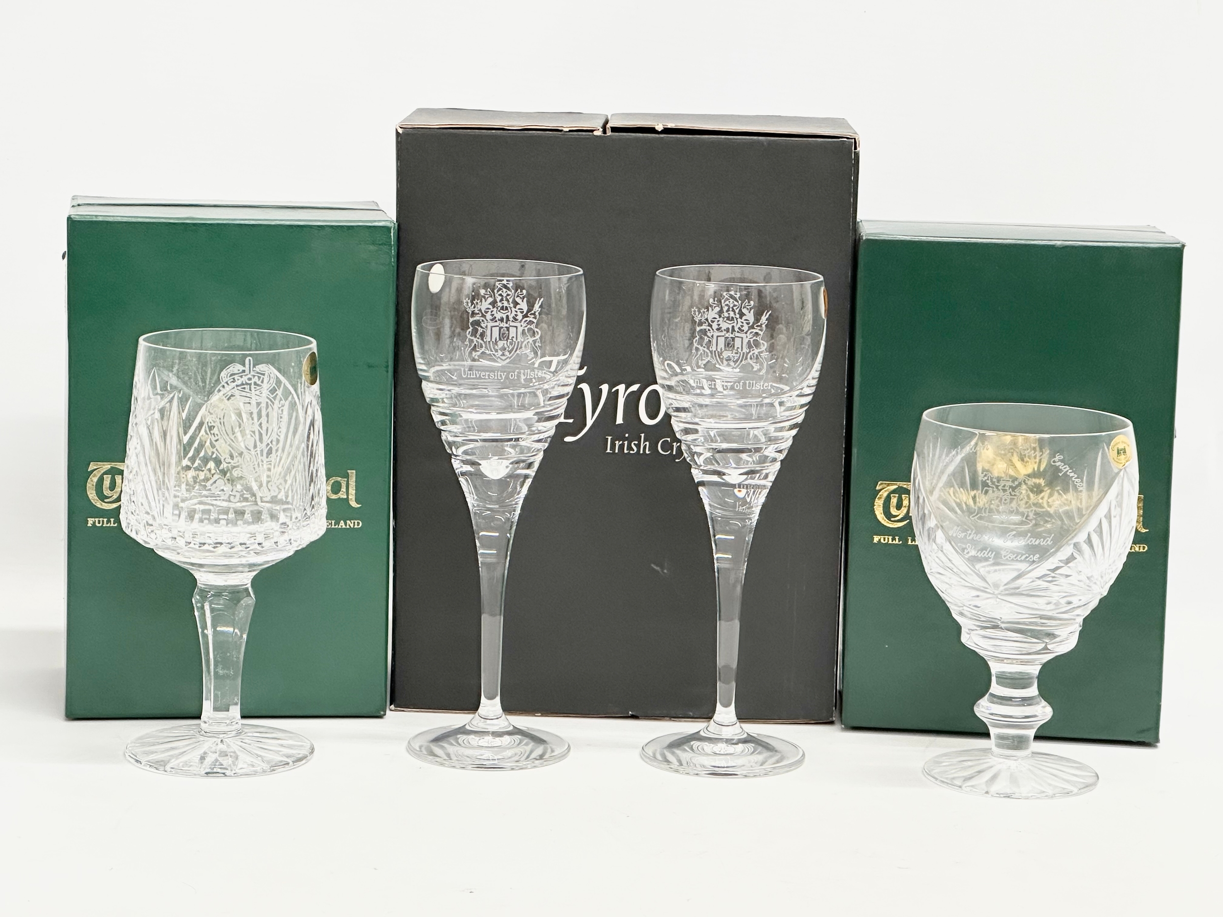 Tyrone Crystal with boxes. A pair of University of Ulster wine glasses 20cm. A Belfast Medical