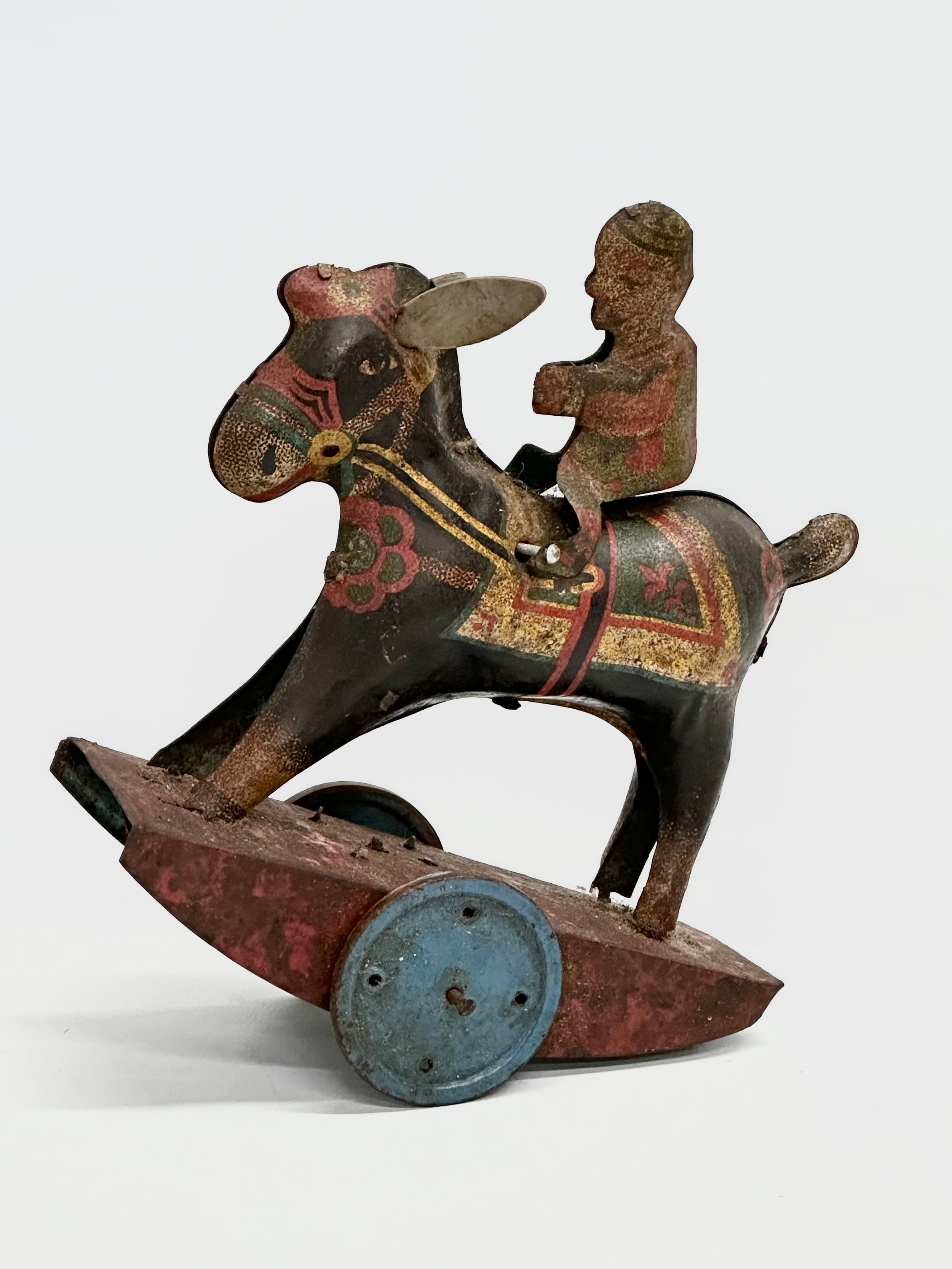 A vintage ‘Peter Pan’ series Stubborn mechanical rocking clown on horse. 15x17cm