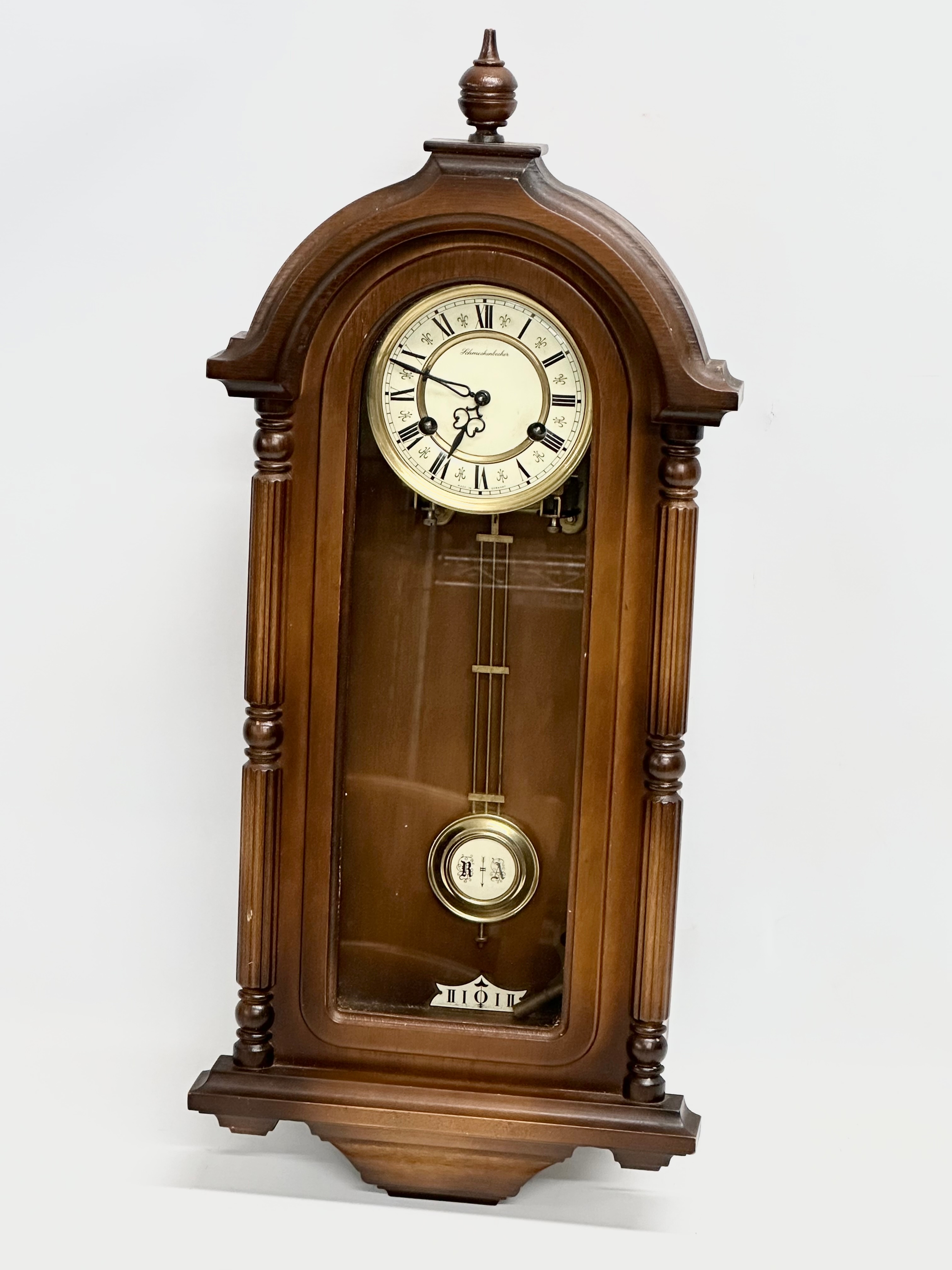 A 19th century style Schmeckenbecker wall clock. With key and pendulum. 63cm