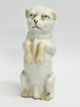 A 19th Century English pottery dog salt figurine. 10.5cm