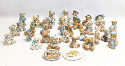 A collection of Cherished Teddies figures. Priscilla Hillman.