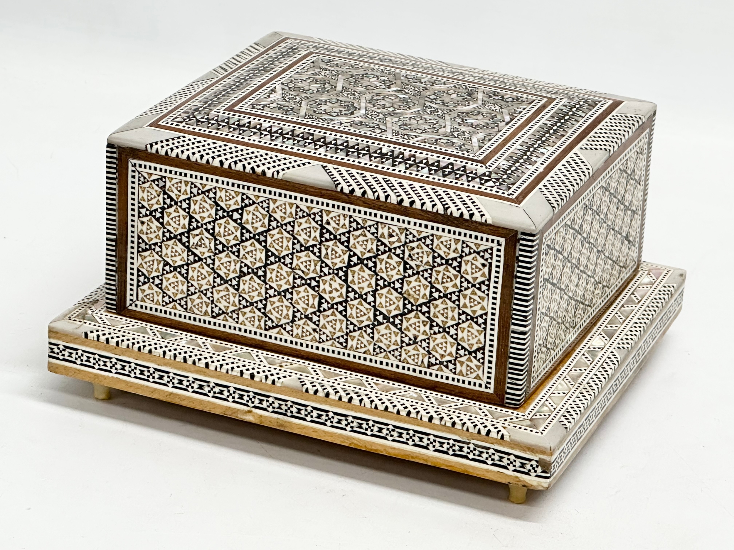 A Mother of Pearl inlaid musical cigarette box. 19x17x11cm