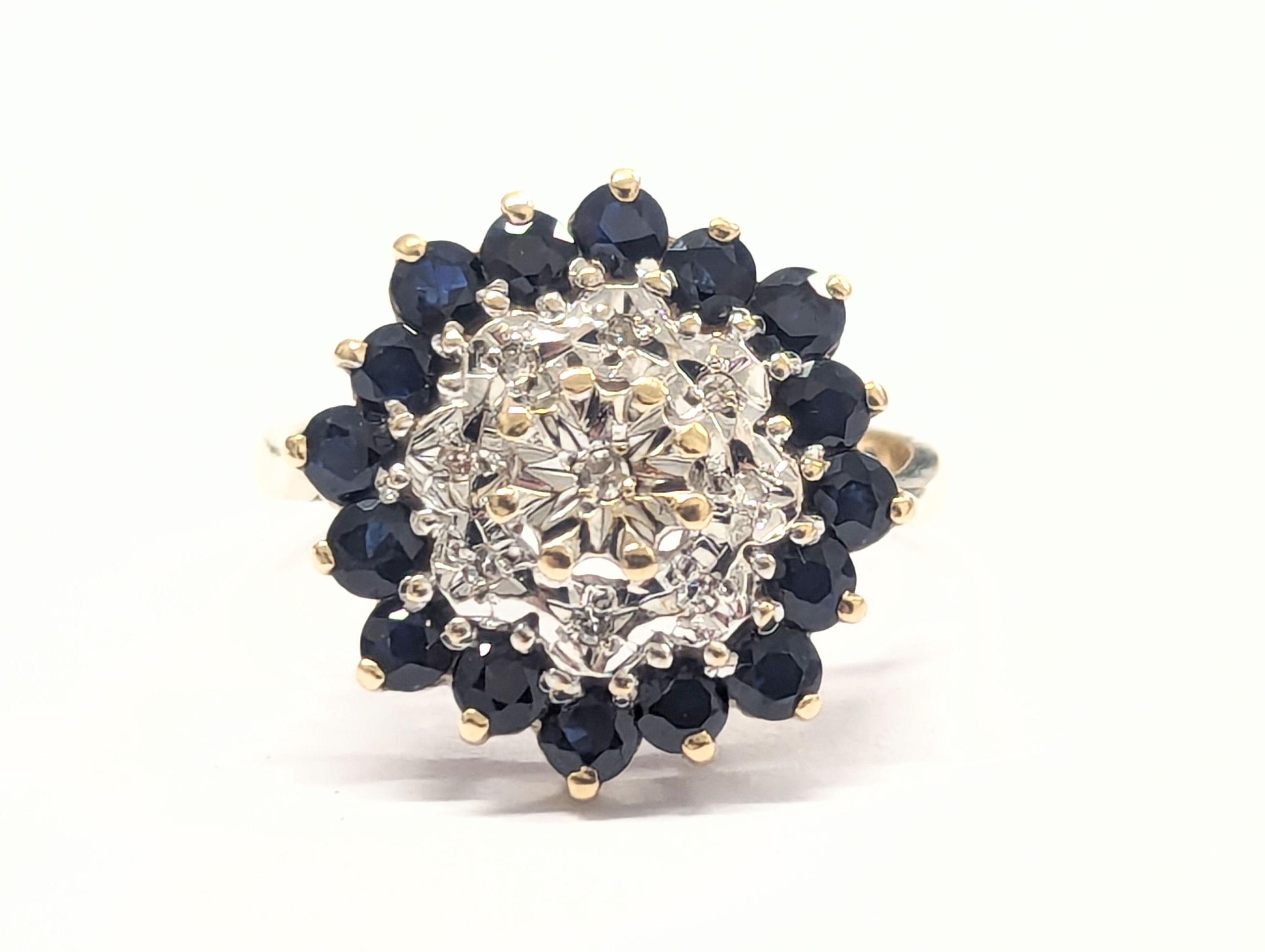 A 9ct gold, diamond and sapphire ring. 3.88g. Size UK K 1/2.