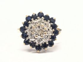 A 9ct gold, diamond and sapphire ring. 3.88g. Size UK K 1/2.