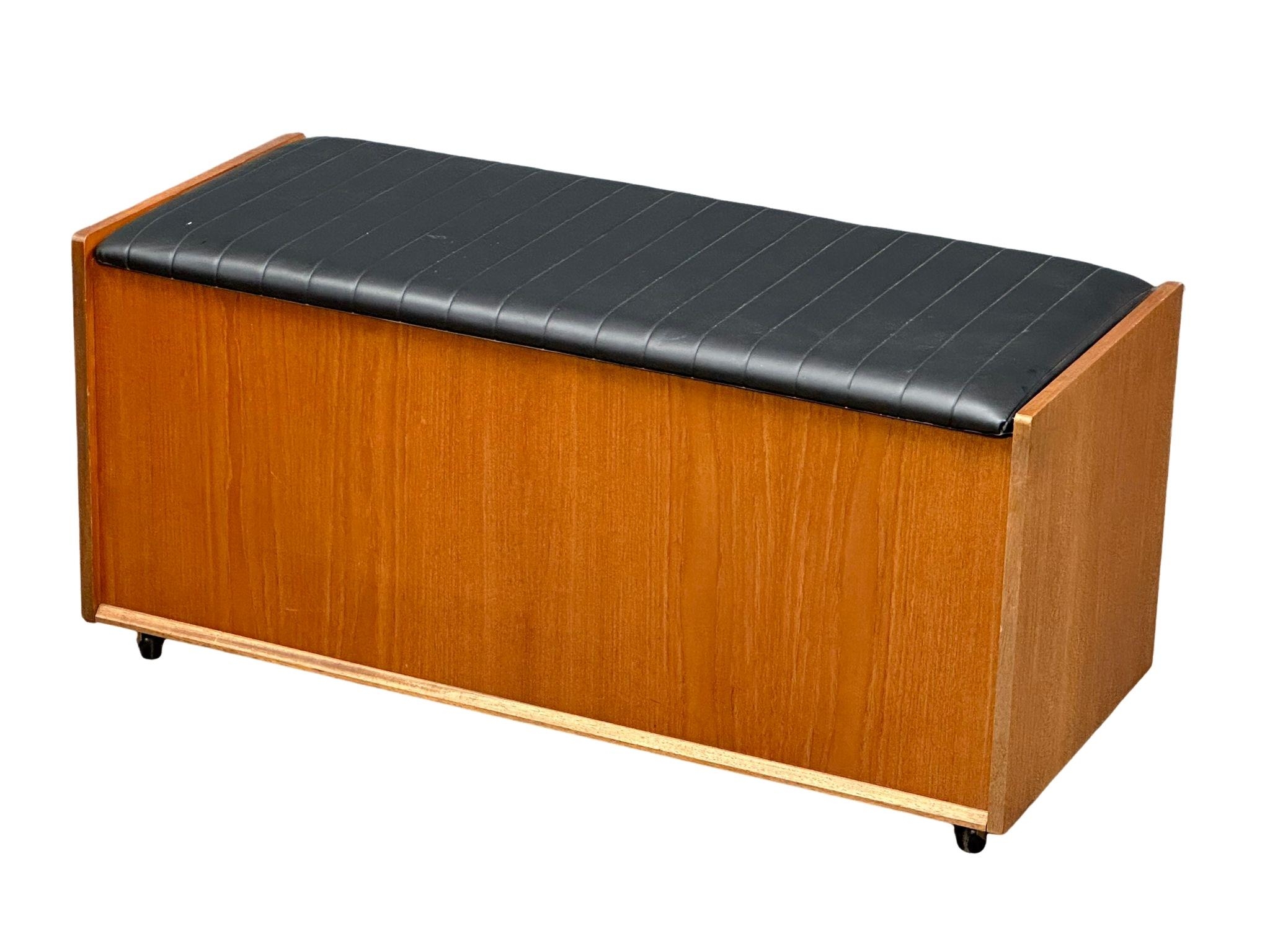 A Mid Century teak ottoman storage box designed by Frank Guille for Austinsuite. 100x42x48cm