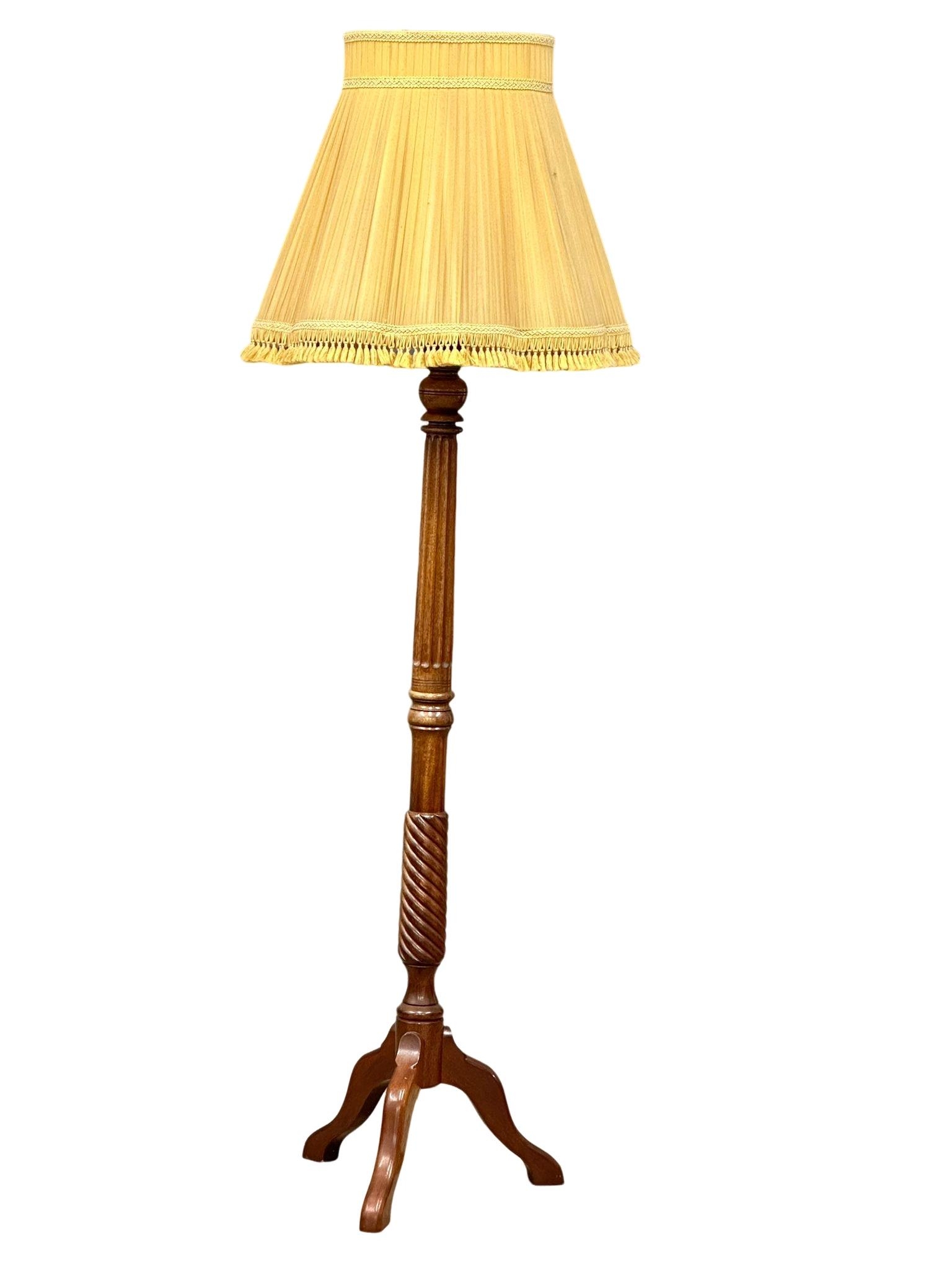 A mahogany standard lamp. 175cm